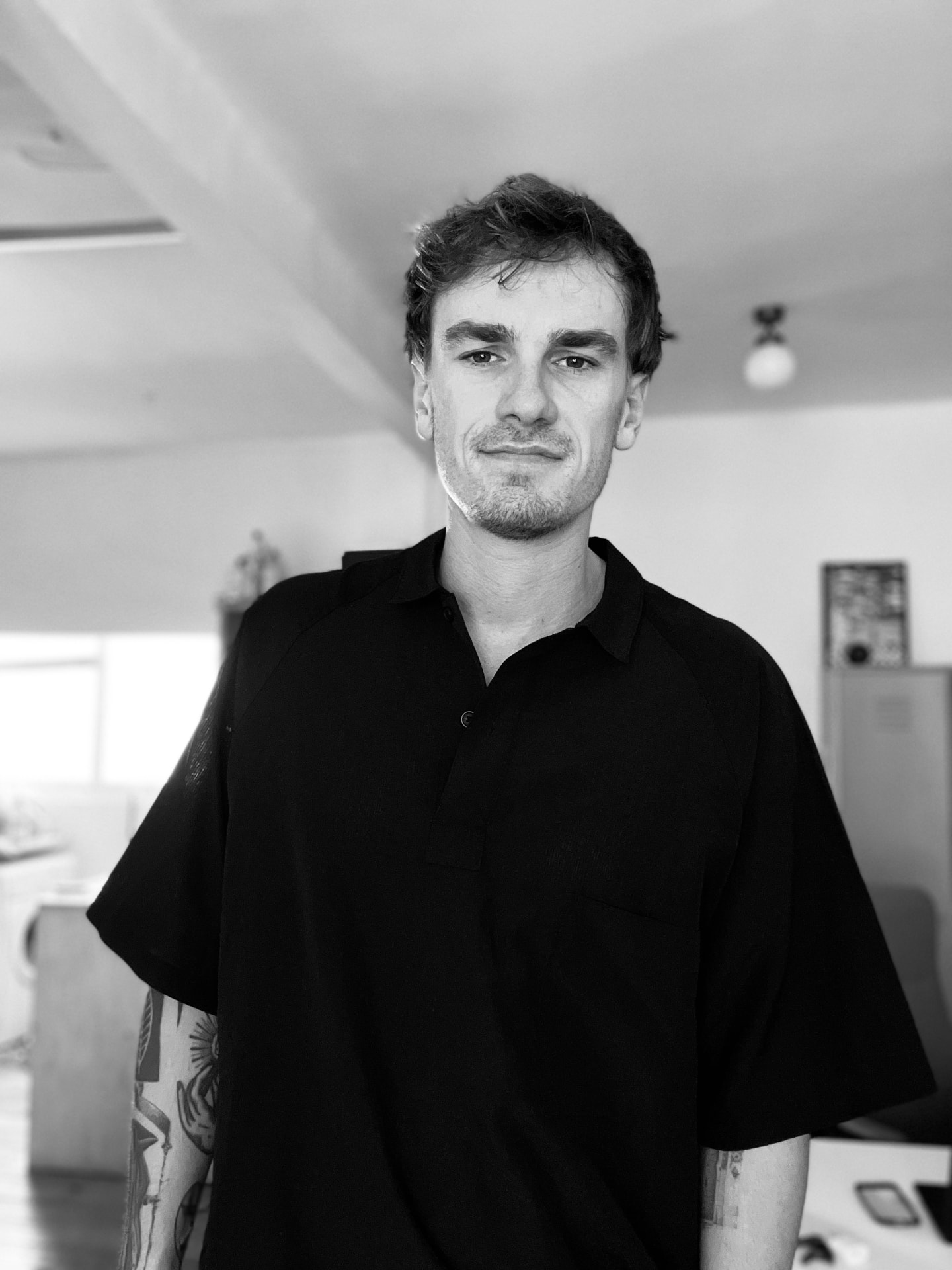 Christian Lee standing for a black-and-white portrait